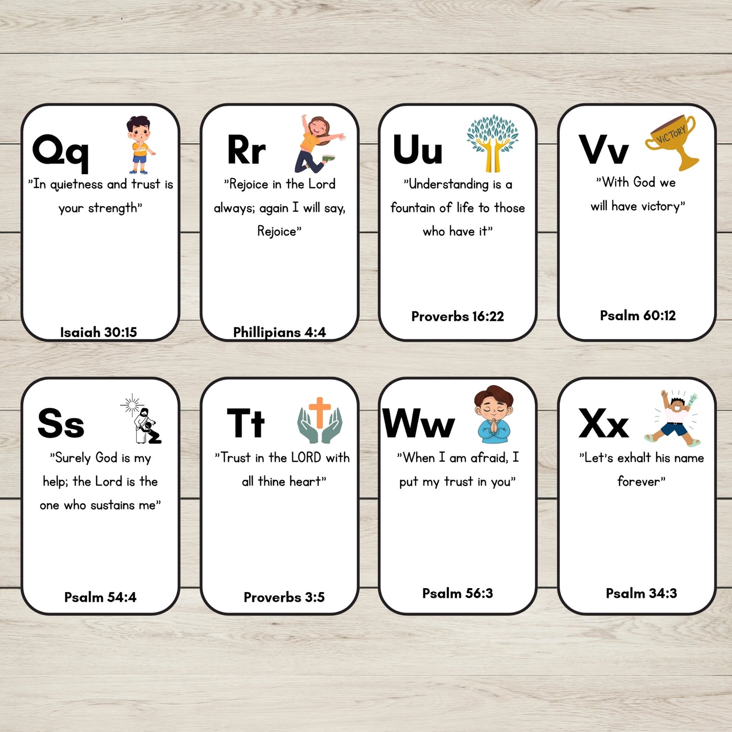Eight Alphabet Bible Verse Cards, arranged in two rows on a light wood background. The cards feature uppercase letters from Q to X, biblical scripture quotes, and small cartoon illustrations.