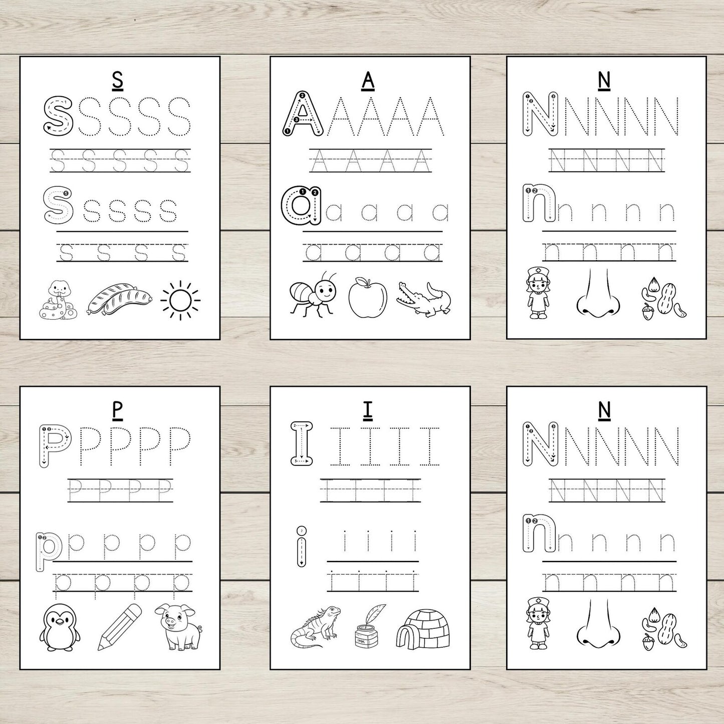 Set of six SATPIN tracing pages on a wooden surface