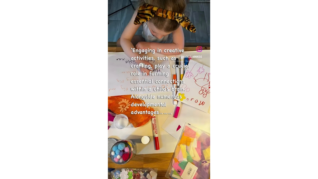 A video showing a young girl sat at a table crafting.