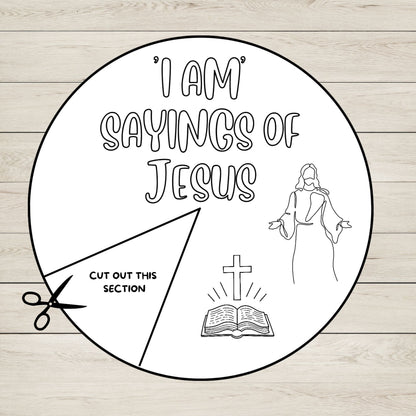 Circular paper with 'I AM SAYINGS OF JESUS' text, a figure of Jesus, a cross, and an open book on a wooden background.