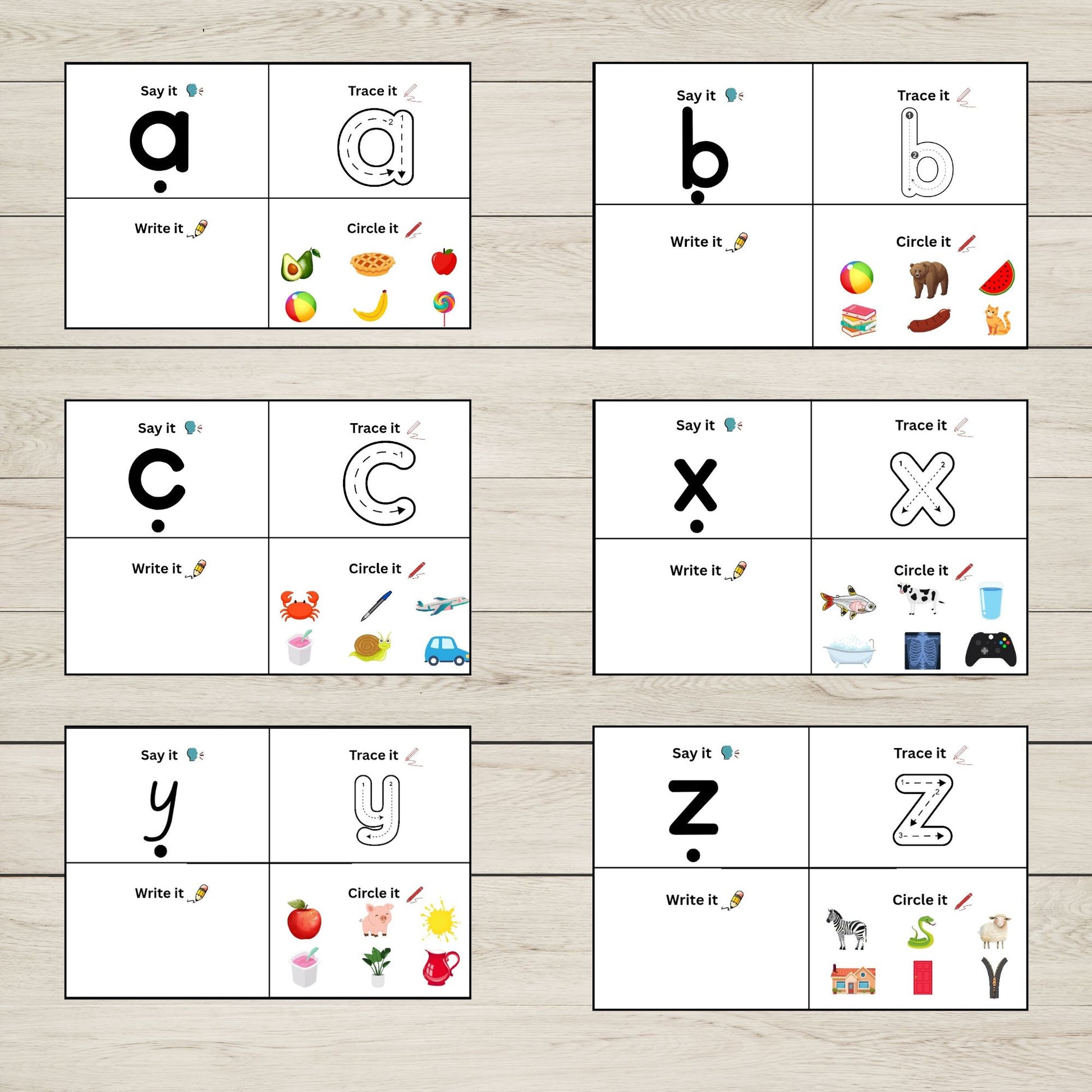 Educational posters with alphabet letters, say it, trace it, write it, and circle it exercises on a wooden surface.