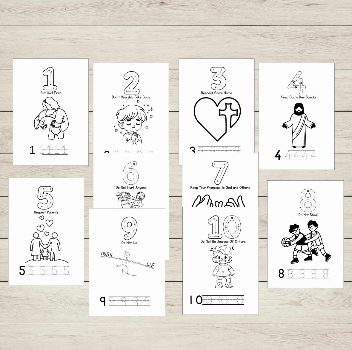 Set of ten black and white illustrated ten commandments sheets on a wooden surface