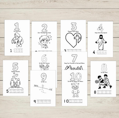 Set of ten black and white illustrated ten commandments sheets on a wooden surface