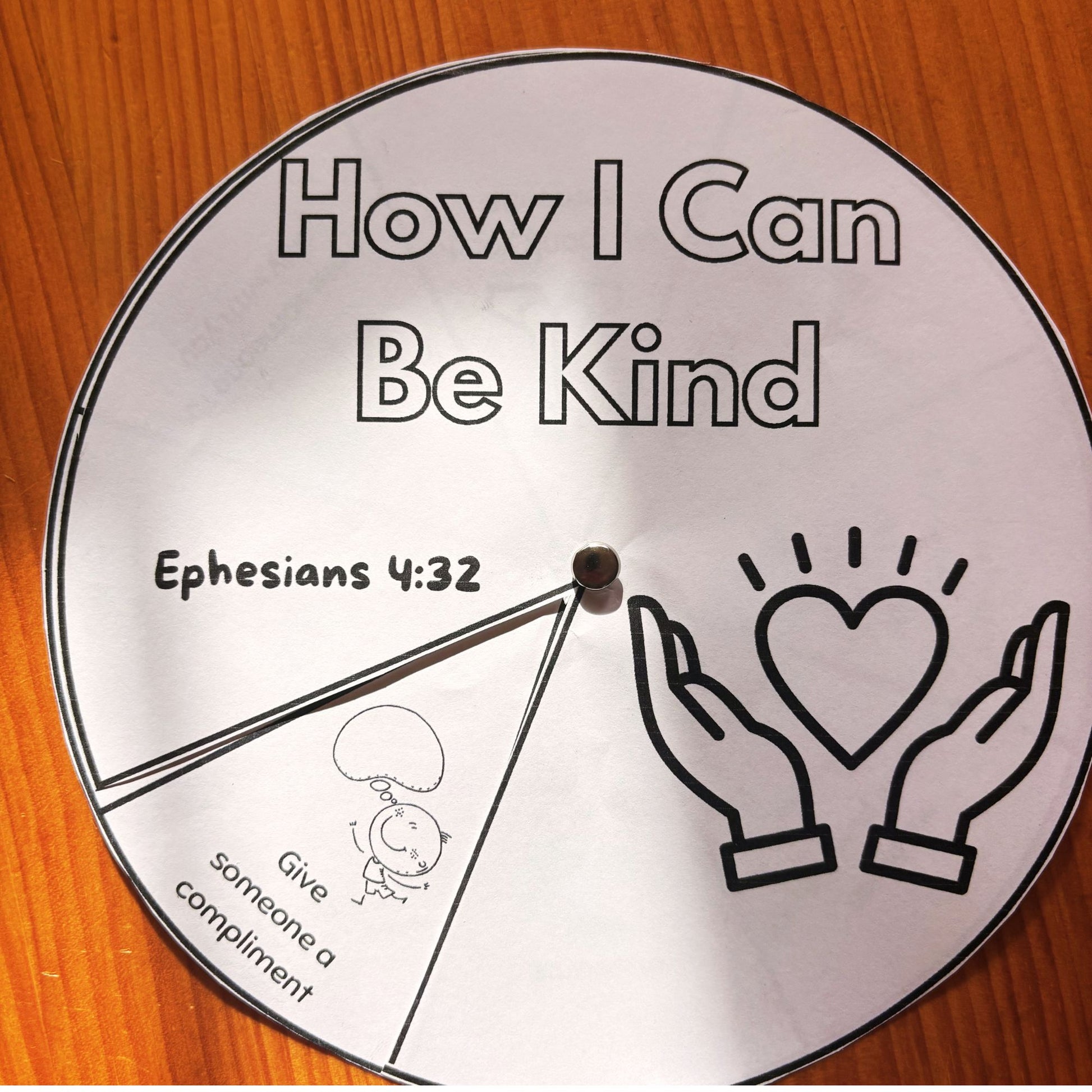 Printed Kindness Wheel Spinner Craft assembled and ready to use for teaching random acts of kindness in Sunday School or homeschool.