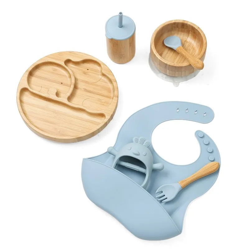 "A bamboo and blue bib, beaker, bowl, spoon, fork for babies and toddlers.'