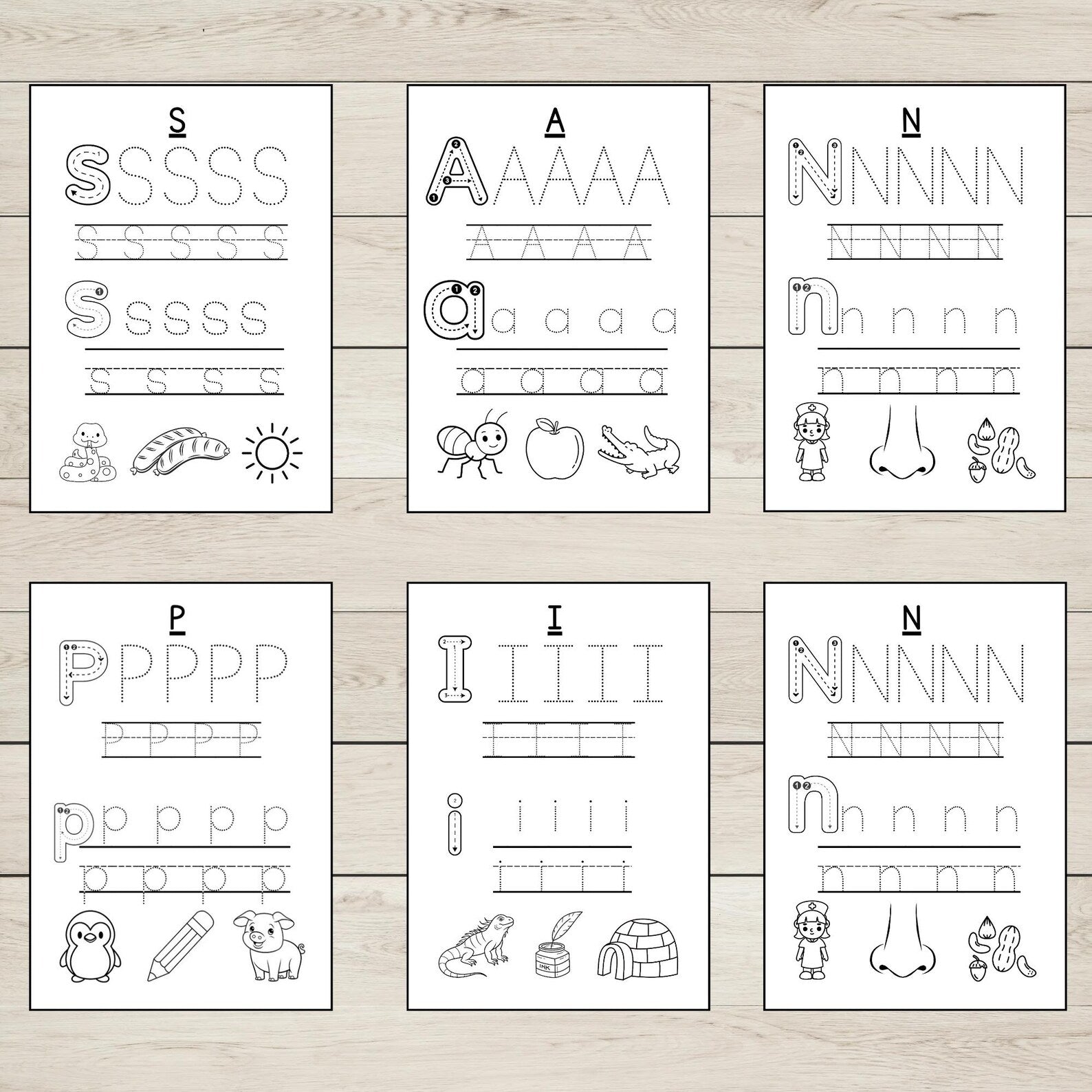 Set of six SATPIN tracing pages on a wooden surface