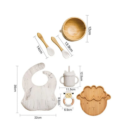 "A marble and bamboo bib, rattle, cup, spoon, fork, bowl, sheep shaped plate for babies and toddlers." 