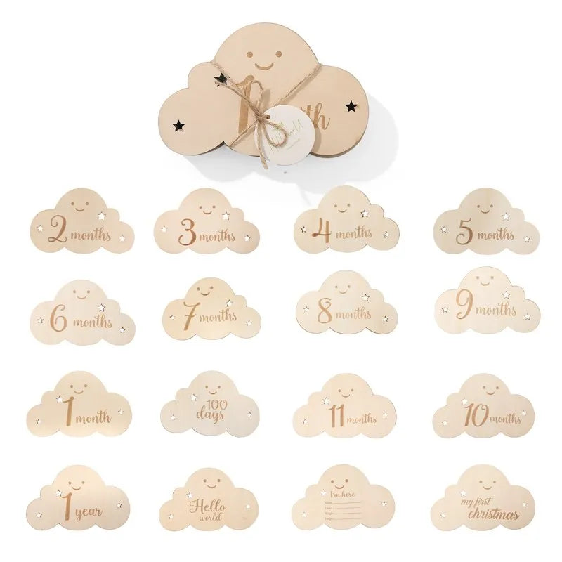 "A set of wooden baby milestone cloud shaped cards."