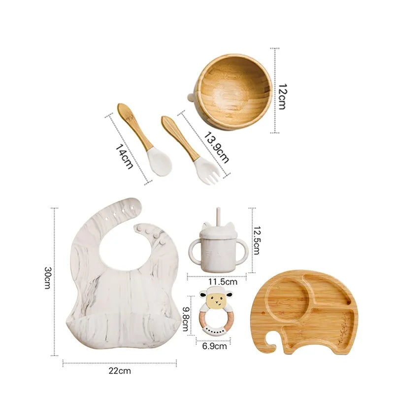 "A marble and bamboo bib, rattle, cup, spoon, fork, bowl, elephant shaped plate for babies and toddlers." 