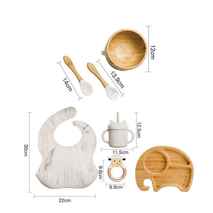 "A marble and bamboo bib, rattle, cup, spoon, fork, bowl, elephant shaped plate for babies and toddlers." 