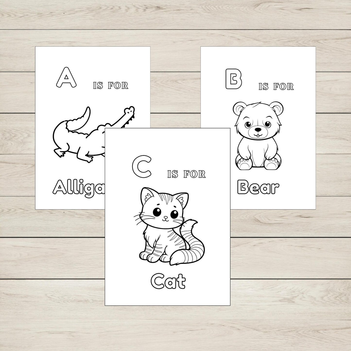 Three colouring pages on a wooden surface with letters and animals.