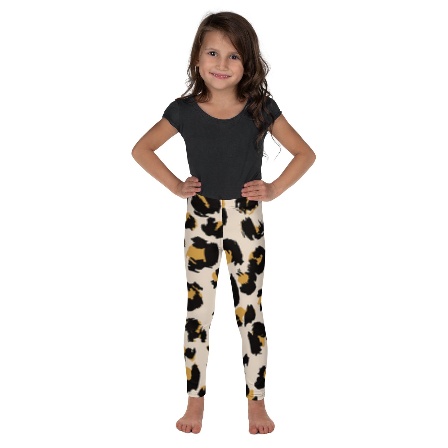 "A little girl wearing leopard print leggings."