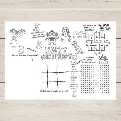 Children's birthday activity sheet with various games and colouring prompts on a wooden surface.