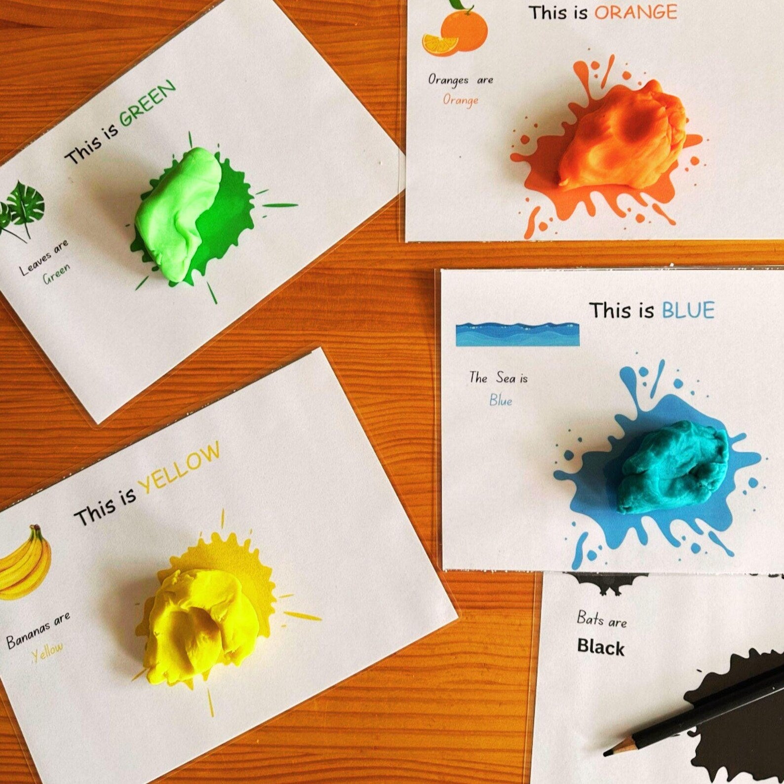 Colour recognition playdough mats for green, orange, blue, and black.