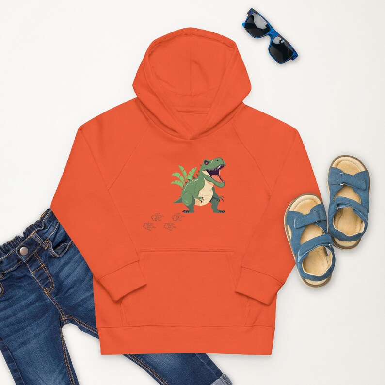 "Blue jean orange dinosaur hoodie and blue sandals."