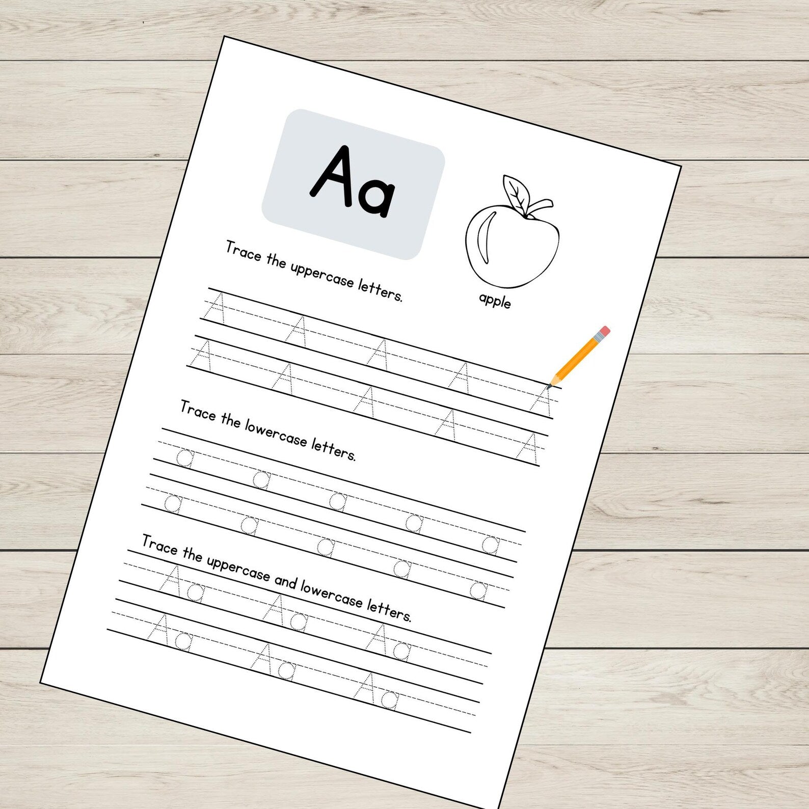 Educational worksheet for tracing uppercase and lowercase 'A's with an apple illustration on a wooden surface.