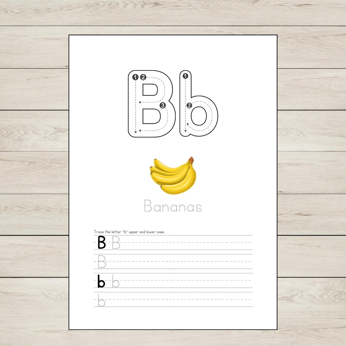 Educational page with letter 'B' tracing and banana illustration on a wooden surface
