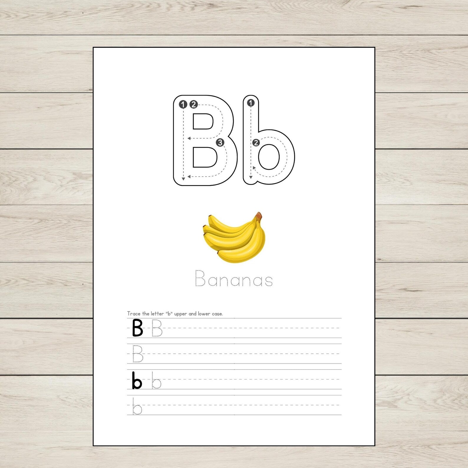 Educational page with letter 'B' tracing and banana illustration on a wooden surface