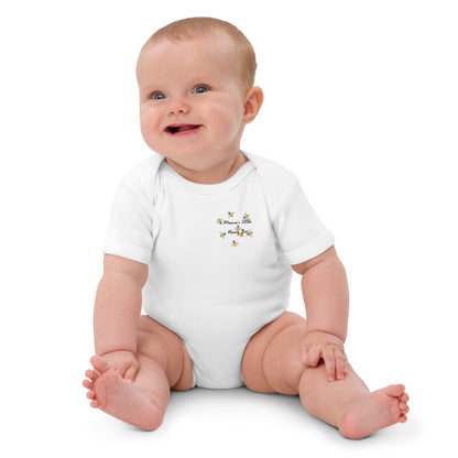 "A baby sat laughing wearing a white mama's honey bee bodysuit."