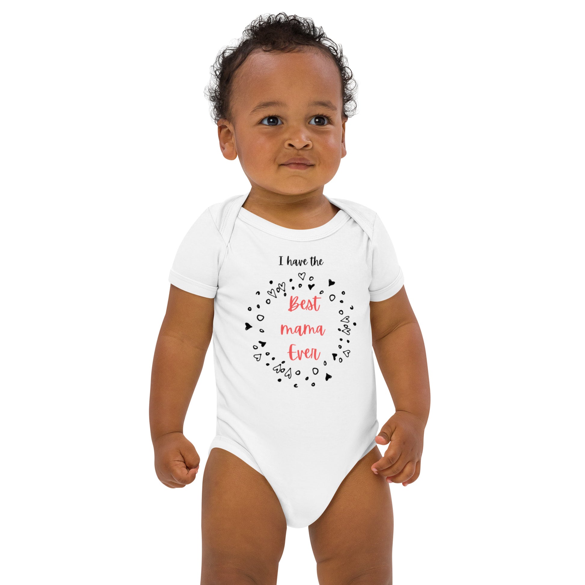 "A toddler boy wearing a white bodysuit with I have the best mama ever print."